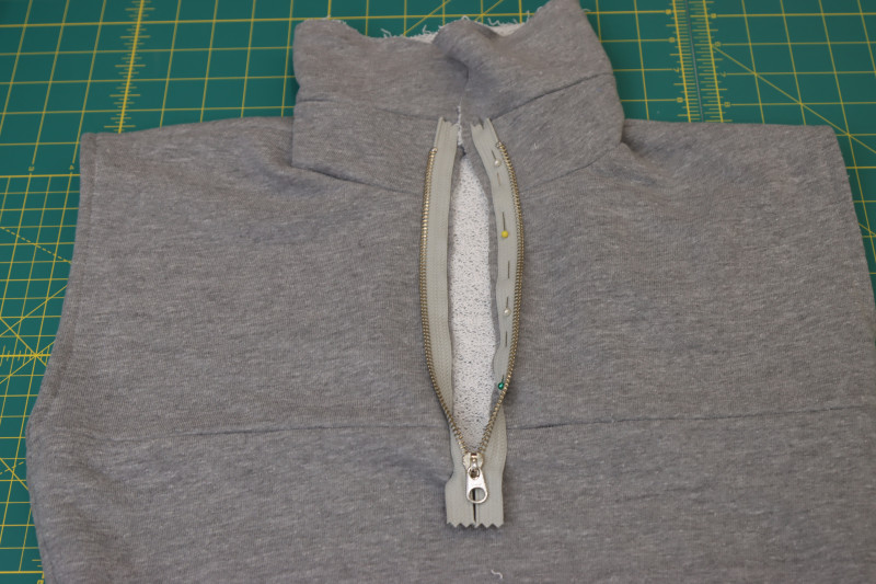 How To Pin Sew Other Side Of Zipper Right Sides Together With Other Side Of Neckline Slit - 9 Inch Metal Teeth Zipper - Mood Fabrics - Reef Sleeveless Cover Up Free Sewing Pattern Tutorial - MDF535 - Mood Fabrics Sewciety Blog - Pin and sew the other side of the zipper right sides together with the other side of the neckline slit.