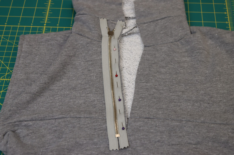 How To Pin Zipper Right Sides Together With Neckline Slit - 9 Inch Metal Teeth Zipper - Mood Fabrics - Reef Sleeveless Cover Up Free Sewing Pattern Tutorial - MDF535 - Mood Fabrics Sewciety Blog - Pin the zipper right sides together with the neckline slit.