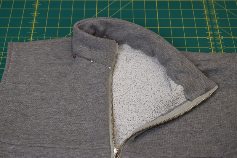 How To Pin Folded Edge Of Inner Collar To Seam Between Outer Collar And Neckline - Heather Gray French Terry - Mood Fabrics - Reef Sleeveless Cover Up Free Sewing Pattern Tutorial - MDF535 - Mood Fabrics Sewciety Blog - Pin the folded edge of the inner collar to the seam between the outer collar and the neckline.