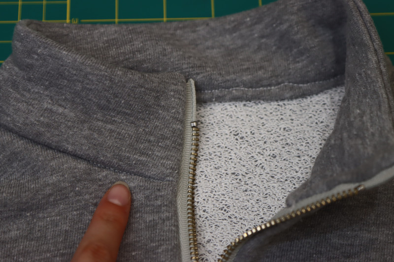 How To Sew Stitch In The Ditch Between Collar And Neckline To Attach Inner Collar - Gutermann Sew All Thread - Mood Fabrics - Reef Sleeveless Cover Up Free Sewing Pattern Tutorial - MDF535 - Mood Fabrics Sewciety Blog - Sew a stitch in the ditch between the collar and the neckline to attach the inner collar to the neckline.