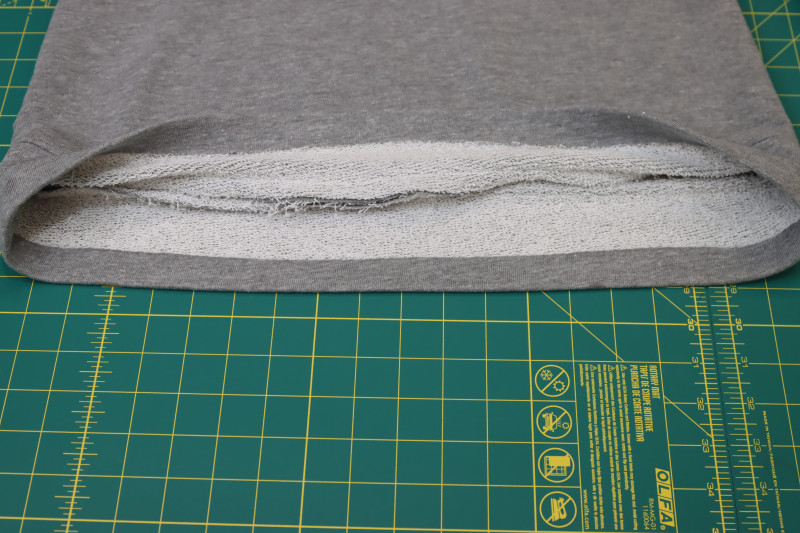 How To Hem Bottom Of Skirt - Heather Gray French Terry - Mood Fabrics - Reef Sleeveless Cover Up Free Sewing Pattern Tutorial - MDF535 - Mood Fabrics Sewciety Blog - Hem the bottom of the skirt.