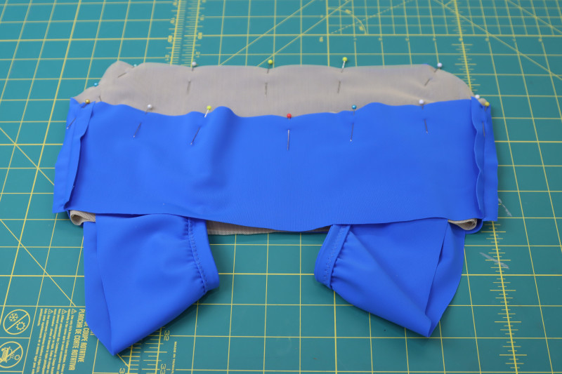 How To Pin Straps Between Lining And Main Fabric - Nude Powernet Mesh - Mood Fabrics - Azure Tankini Skirt Set Free Sewing Pattern Tutorial - MDF533 - Mood Fabrics Sewciety Blog - Pin the straps between the lining and the main fabric.