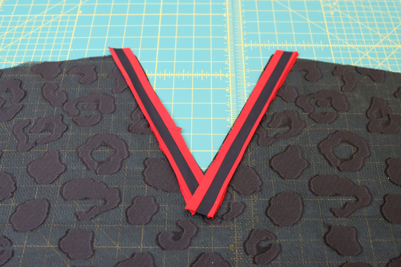 How To Cut Front Neckline Trim - Red Quilting Cotton - Mood Fabrics - Matrix Shawl Collar Ensemble Free Sewing Pattern Tutorial - MDF543 - Mood Fabrics Sewciety Blog - Cut two strips of trim for the front neckline.