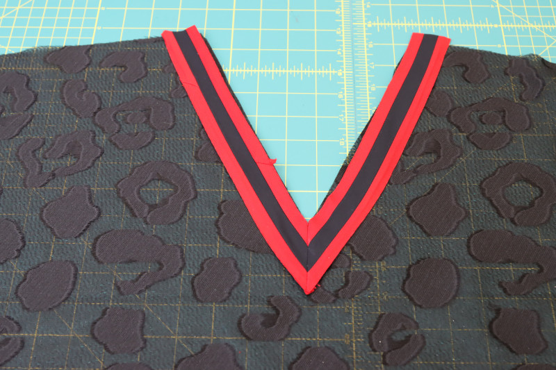 How To Press Front Neckline Trim - Red Quilting Cotton - Mood Fabrics - Matrix Shawl Collar Ensemble Free Sewing Pattern Tutorial - MDF543 - Mood Fabrics Sewciety Blog - Press the front neckline trim open and flat.