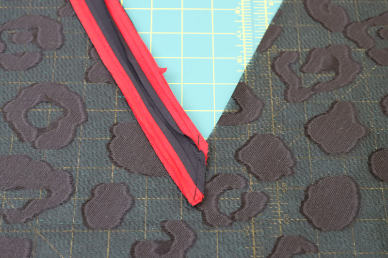 How To Sew Front Neckline Pieces - Red Quilting Cotton - Mood Fabrics - Matrix Shawl Collar Ensemble Free Sewing Pattern Tutorial - MDF543 - Mood Fabrics Sewciety Blog - Sew the front neckline pieces right sides together at an angle.