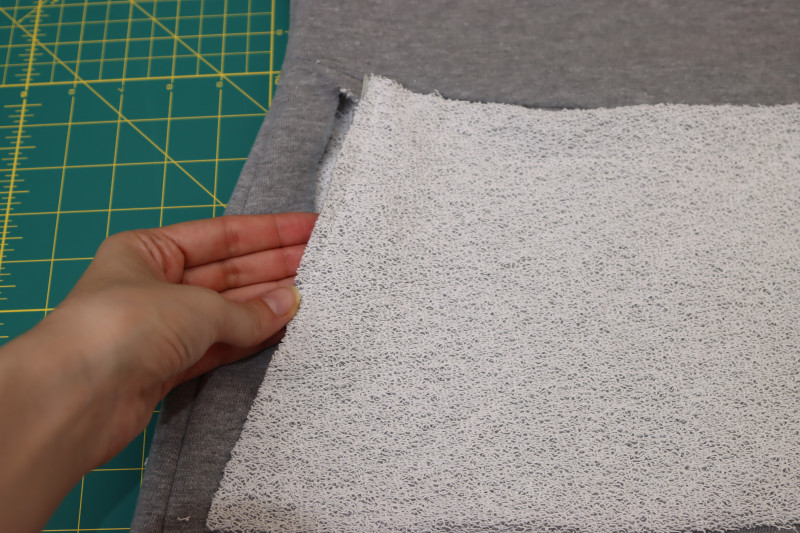 How To Sew Inner Pocket Bag Right Sides Together On Top Of Zipper - 4.5 Inch Metal Teeth Zipper - Mood Fabrics - Reef Sleeveless Cover Up Free Sewing Pattern Tutorial - MDF535 - Mood Fabrics Sewciety Blog - Sew the inner pocket bag right sides together on top of the zipper.