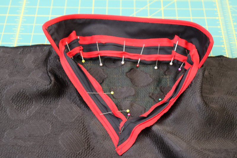 How To Pin Collar Trim Wrong Side Neckline - Textured Burnout Brocade - Mood Fabrics - Matrix Shawl Collar Ensemble Free Sewing Pattern Tutorial - MDF543 - Mood Fabrics Sewciety Blog - Pin the collar and trim to the wrong side of the neckline.