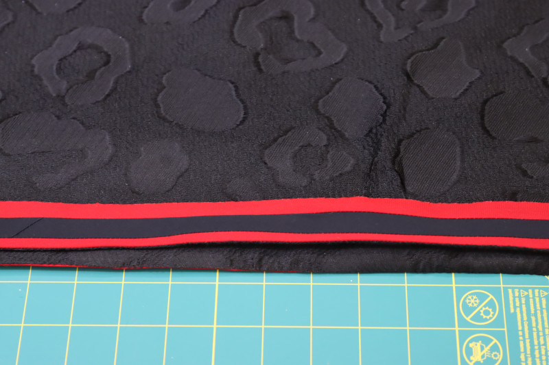 How To Flip Trim Right Side Shirt - Red Quilting Cotton - Mood Fabrics - Matrix Shawl Collar Ensemble Free Sewing Pattern Tutorial - MDF543 - Mood Fabrics Sewciety Blog - Flip the trim to the right side of the shirt.