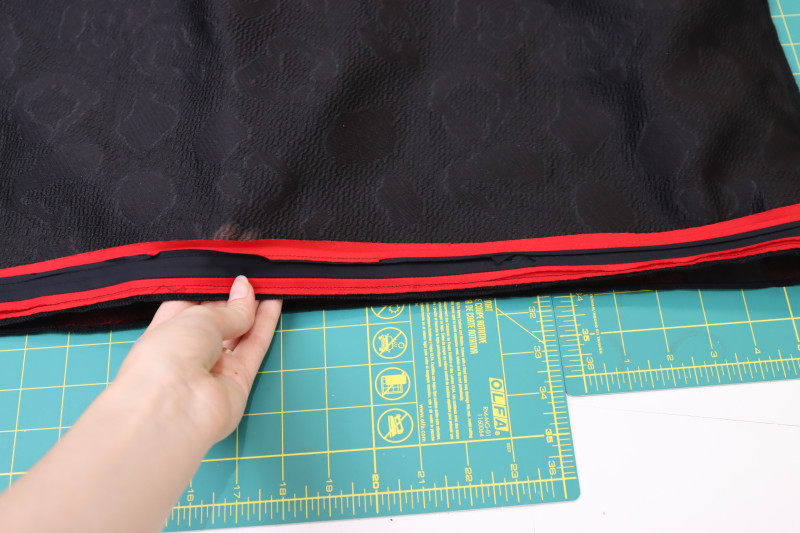 How To Sew Trim Shirt Hem - Red Quilting Cotton - Mood Fabrics - Matrix Shawl Collar Ensemble Free Sewing Pattern Tutorial - MDF543 - Mood Fabrics Sewciety Blog - Sew the trim to the hem of the shirt with ¼ inch seam allowance.