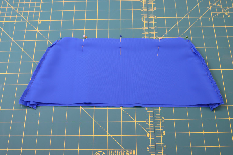 How To Pin Waistlines Of Two Waistbands Right Sides Together - Recycled Swimwear Tricot - Mood Fabrics - Azure Tankini Skirt Set Free Sewing Pattern Tutorial - MDF533 - Mood Fabrics Sewciety Blog - Pin the waistlines of the two waistbands right sides together.