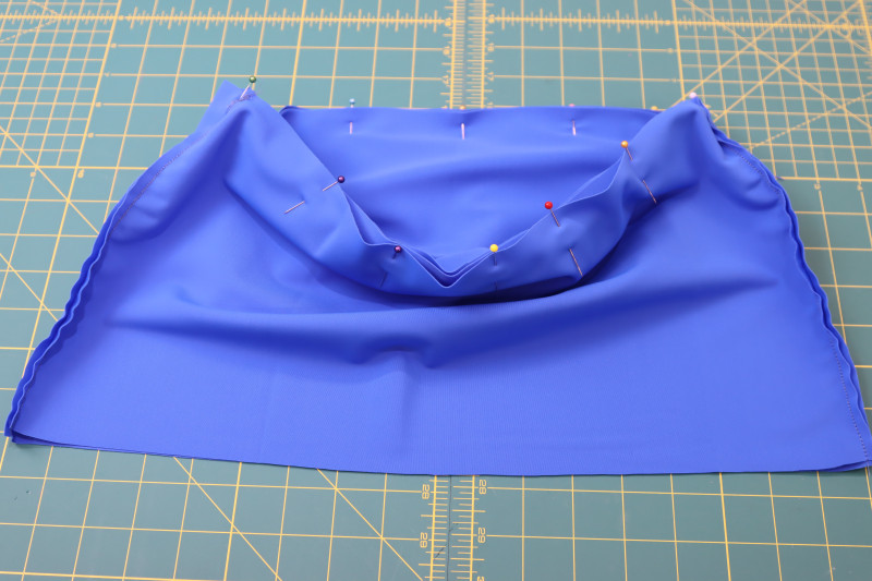 How To Pin Waistband To Waistline Of Skirt Right Sides Together - Recycled Swimwear Tricot - Mood Fabrics - Azure Tankini Skirt Set Free Sewing Pattern Tutorial - MDF533 - Mood Fabrics Sewciety Blog - Pin the waistband to the waistline of the skirt, right sides together.