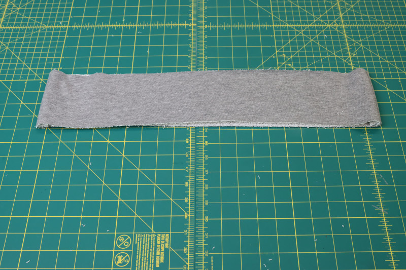 How To Press Side Seams Of Hem Band - Heather Gray French Terry - Mood Fabrics - Reef Sleeveless Cover Up Free Sewing Pattern Tutorial - MDF535 - Mood Fabrics Sewciety Blog - Press the side seams of the hem band.