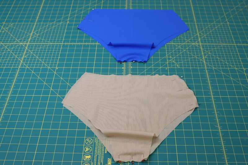 How To Pin Crotch Seams And Mirrored Side Seams For Main Fabric And Lining Bikini Bottoms - Nude Powernet Mesh - Mood Fabrics - Azure Tankini Skirt Set Free Sewing Pattern Tutorial - MDF533 - Mood Fabrics Sewciety Blog - Pin the crotch seams and mirrored side seams for the main fabric and lining bikini bottoms.