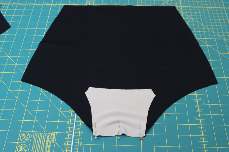 How To Pin Right Side Of Gusset To Wrong Side Of Bikini Bottom Back - Recycled Swimwear Tricot - Mood Fabrics - Antikythera One Shoulder Bikini Free Sewing Pattern Tutorial - MDF531 - Mood Fabrics Sewciety Blog - Pin the right side of the gusset to the wrong side of the bikini bottom back.