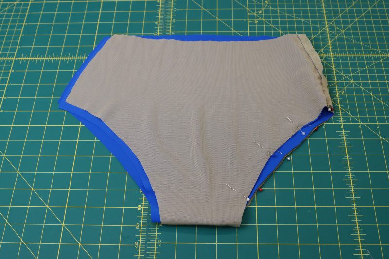 How To Pin Lining To Main Fabric Around Leg Hole - Nude Powernet Mesh - Mood Fabrics - Azure Tankini Skirt Set Free Sewing Pattern Tutorial - MDF533 - Mood Fabrics Sewciety Blog - Pin the lining to the main fabric around the leg hole.