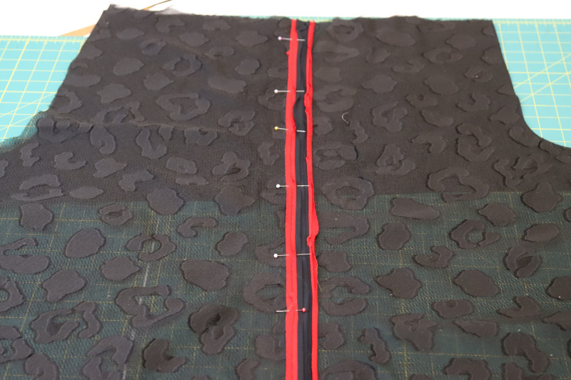 How To Pin Trim Pants Side Seam - Textured Burnout Brocade - Mood Fabrics - Matrix Shawl Collar Ensemble Free Sewing Pattern Tutorial - MDF543 - Mood Fabrics Sewciety Blog - Pin the trim right sides together on top of the side seam.