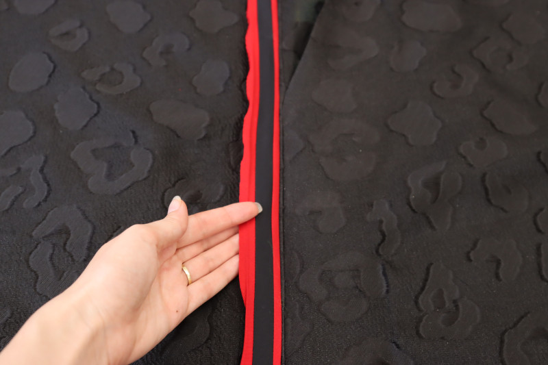 How To Press Trim Right Side Out - Red Quilting Cotton - Mood Fabrics - Matrix Shawl Collar Ensemble Free Sewing Pattern Tutorial - MDF543 - Mood Fabrics Sewciety Blog - Press the trim so that the right side is facing out.