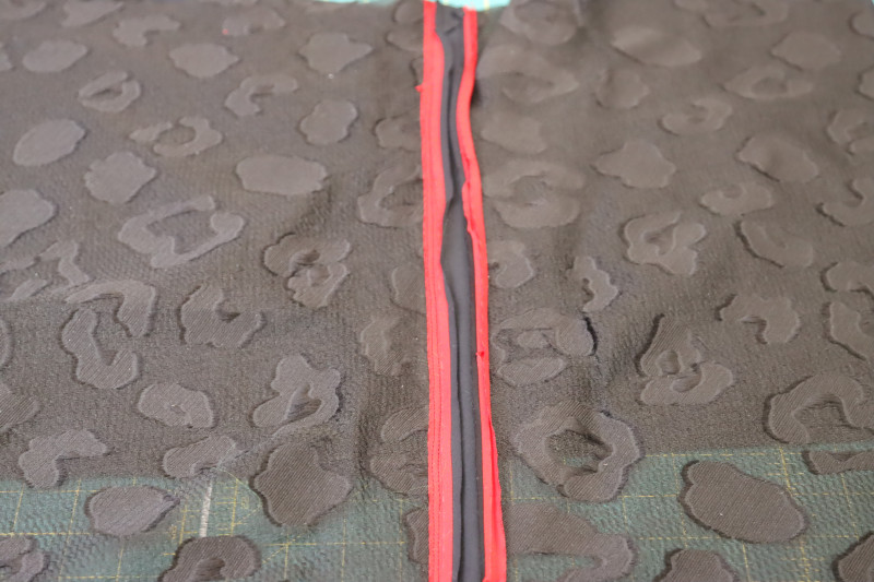 How To Sew Trim Side Seam - Red Quilting Cotton - Mood Fabrics - Matrix Shawl Collar Ensemble Free Sewing Pattern Tutorial - MDF543 - Mood Fabrics Sewciety Blog - Sew the trim to the side seam.