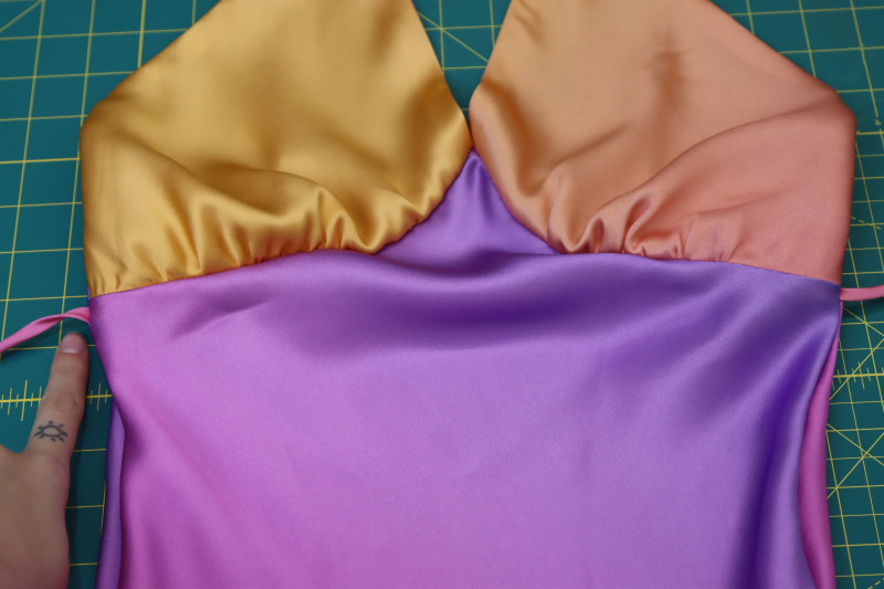 How To Insert Waist Ties Directly Under Bust Before Second French Seam - Silk Charmeuse Print - Mood Fabrics - Alexandrite Sunset Silk Charmeuse Dress Free Sewing Pattern Tutorial - MDF529 - Mood Fabrics Sewciety Blog - Insert the waist ties directly under the bust before sewing the second seam in the French seam.