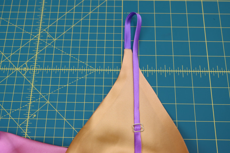 How To Insert Front Strap Top Strap Adjuster - Gold Metal Strap Sliders - Mood Fabrics - Alexandrite Sunset Silk Charmeuse Dress Free Sewing Pattern Tutorial - MDF529 - Mood Fabrics Sewciety Blog - Insert the front strap into the top strap adjuster.