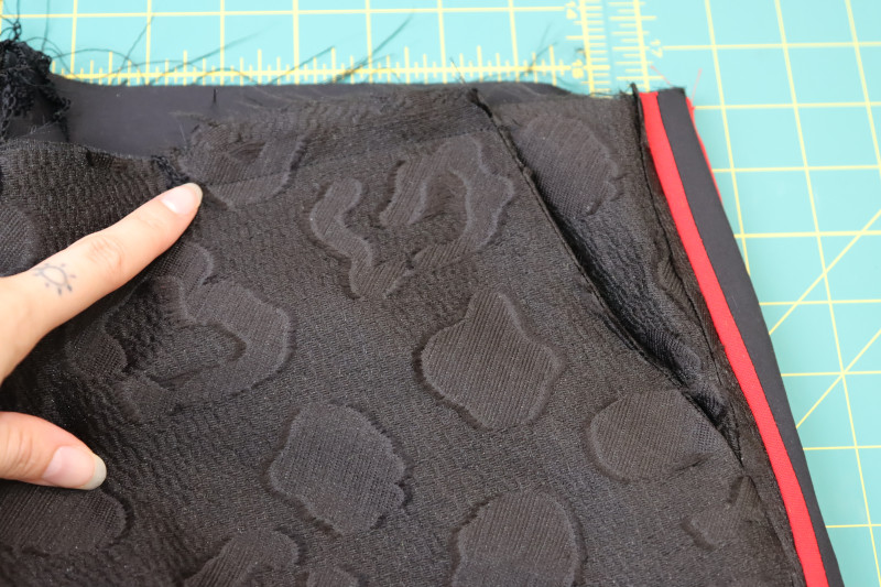How To Topstitch Pocket Bags Front Waistline - Textured Burnout Brocade - Mood Fabrics - Matrix Shawl Collar Ensemble Free Sewing Pattern Tutorial - MDF543 - Mood Fabrics Sewciety Blog - Staystitch the tops of the pocket bags to the front waistline.