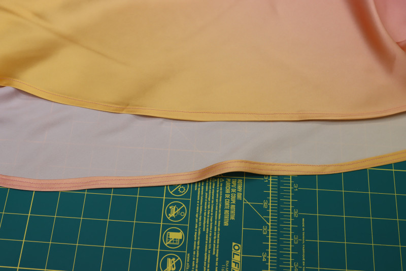 How To Sew Double Folded ¼ Inch Hem Bottom Dress - Gutermann Sew All Thread - Mood Fabrics - Alexandrite Sunset Silk Charmeuse Dress Free Sewing Pattern Tutorial - MDF529 - Mood Fabrics Sewciety Blog - Sew a double folded ¼ inch hem into the bottom of the dress.
