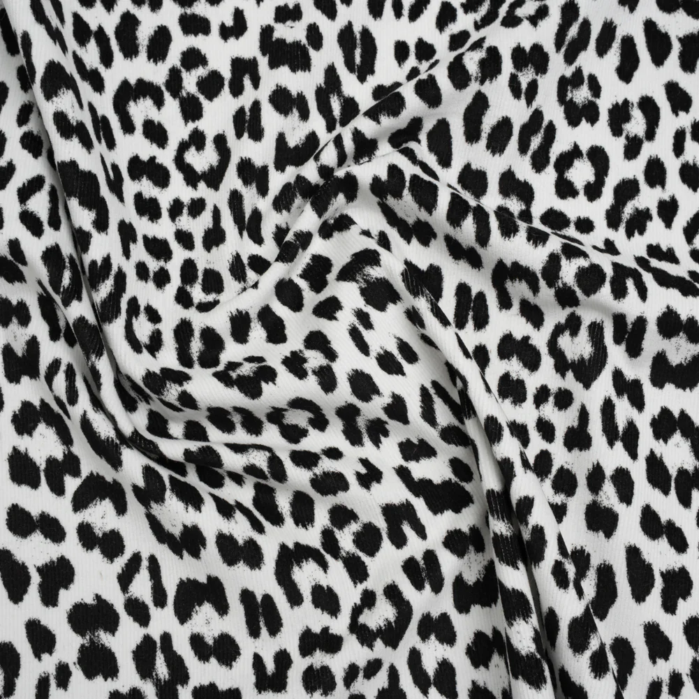 Stretch Cotton Corduroy Print Made in Italy - Black and White Cheetah Spots - Deadstock fabric perfect for Free Summer Vacation Capsule Wardrobe Sewing Projects such as the Biarritz Skort Sewing Pattern free PDF download from Mood Fabrics Sewciety Blog.