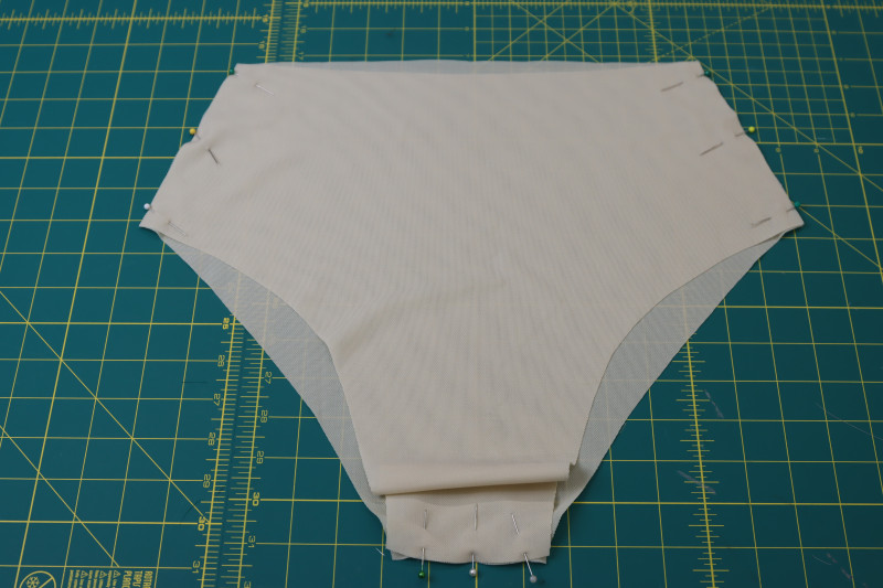 How To Pin Front Back Bottom Lining Side Crotch Seams - Nude Powernet Mesh - Mood Fabrics - Amber Two Piece Cheeky Swimsuit Free Sewing Pattern Tutorial - MDF540 - Mood Fabrics Sewciety Blog - Pin the front and back bottom lining pieces at the side and crotch seams.