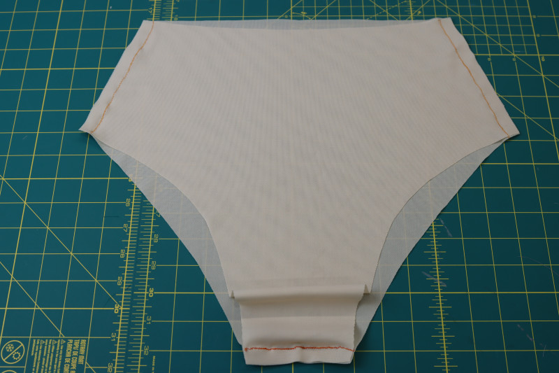 How To Sew Bottom Lining Side Crotch Seams - Nude Powernet Mesh - Mood Fabrics - Amber Two Piece Cheeky Swimsuit Free Sewing Pattern Tutorial - MDF540 - Mood Fabrics Sewciety Blog - Sew the bottom linings at the side and crotch seams.