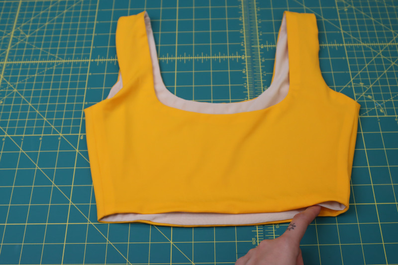 How To Flip Top Through Waistline Hole - UV Protective Swimwear Tricot - Mood Fabrics - Amber Two Piece Cheeky Swimsuit Free Sewing Pattern Tutorial - MDF540 - Mood Fabrics Sewciety Blog - Flip the top right sides out through the hole in the waistline.
