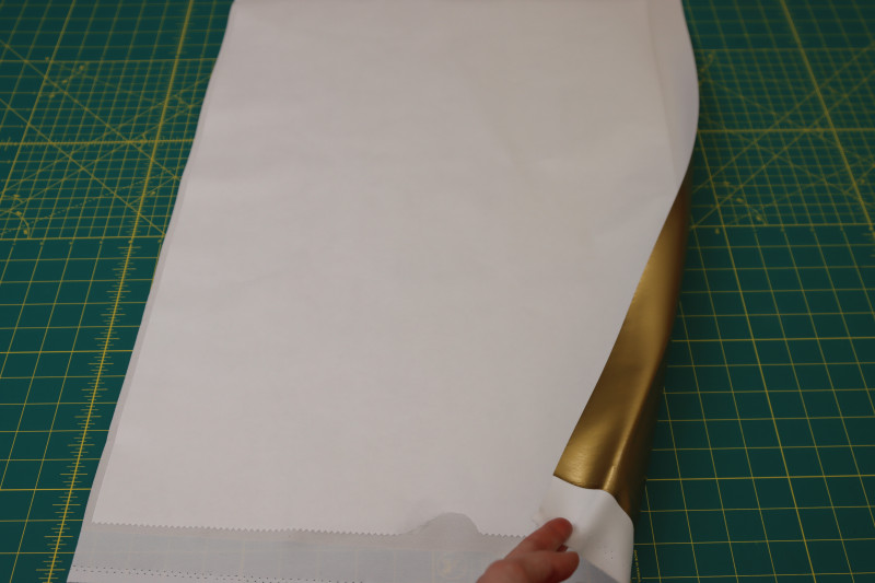 How To Place Webbing Wrong Side Faux Latex - Stretch Web Adhesive - Mood Fabrics - Fiona Athletic Set Free Sewing Pattern Tutorial - MDF537 - Mood Fabrics Sewciety Blog - Stick the adhesive side of the webbing to the wrong side of the faux latex.
