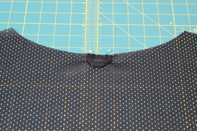 How To Pin Locker Loop Back Neckline - Athletic Mesh - Mood Fabrics - Fiona Athletic Set Free Sewing Pattern Tutorial - MDF537 - Mood Fabrics Sewciety Blog - Pin the locker loop to the center back neckline.