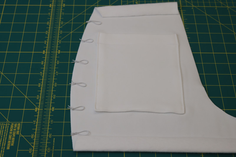 How To Layout Elastic Loops Back Side Seams - Elastic Beading Cord - Mood Fabrics - Fiona Athletic Set Free Sewing Pattern Tutorial - MDF537 - Mood Fabrics Sewciety Blog - Evenly space out the elastic loops on the side seams of the backs of the shorts.