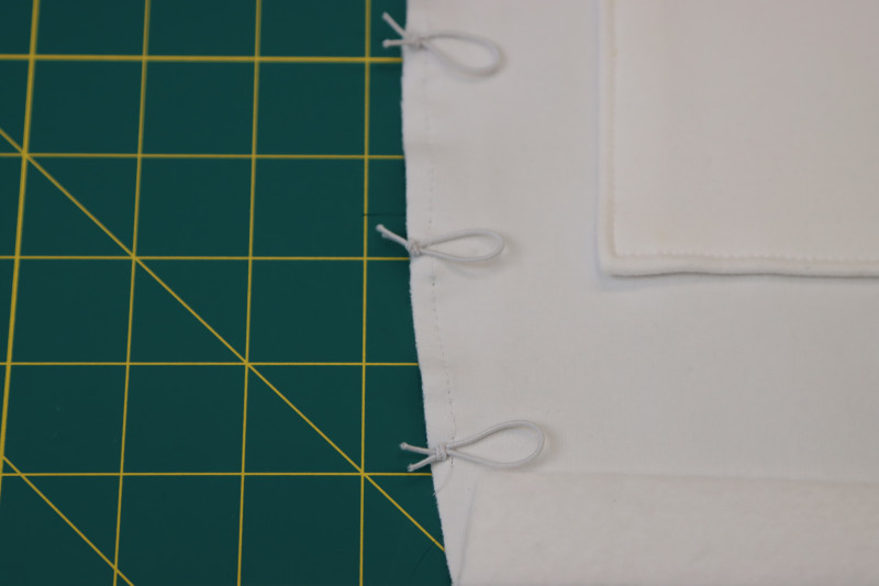 How To Stay Stitch Elastic Loops Back Side Seams - Elastic Beading Cord - Mood Fabrics - Fiona Athletic Set Free Sewing Pattern Tutorial - MDF537 - Mood Fabrics Sewciety Blog - Staystitch over the elastic loops.