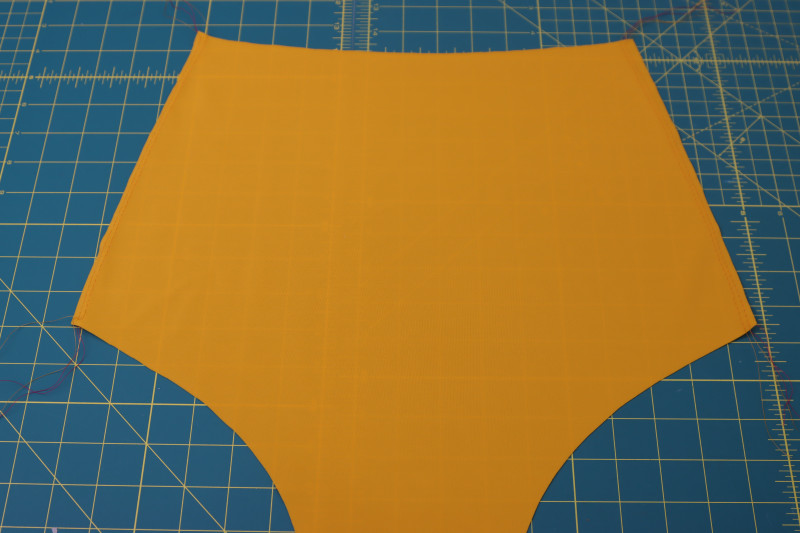 How To Sew Main Fabric Front Bottom Sides - Gutermann Sew All Thread - Mood Fabrics - Amber Two Piece Cheeky Swimsuit Free Sewing Pattern Tutorial - MDF540 - Mood Fabrics Sewciety Blog - Sew two parallel straight stitches along the sides of the main fabric front bottom piece.