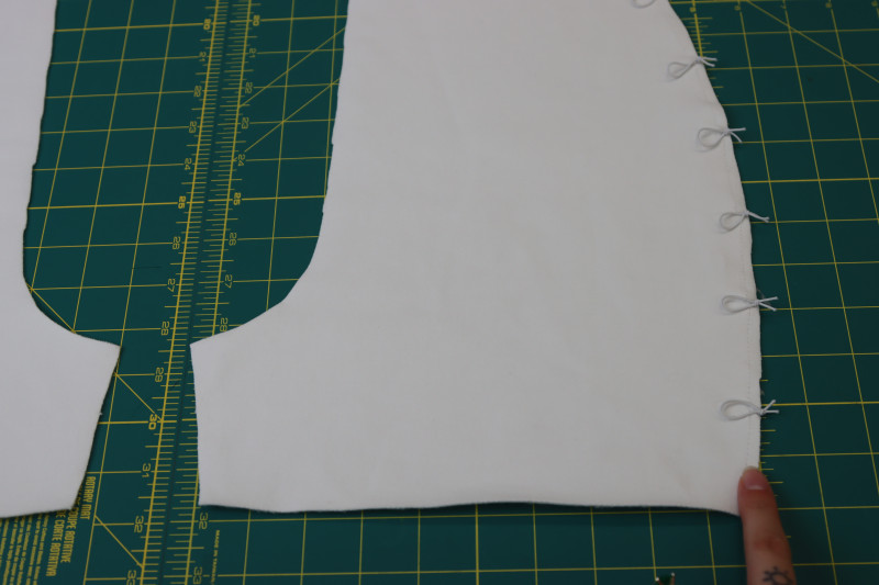 How To Stay Stitch Loops Front Side Seams - Elastic Beading Cord - Mood Fabrics - Fiona Athletic Set Free Sewing Pattern Tutorial - MDF537 - Mood Fabrics Sewciety Blog - Staystitch the loops to the side seam of the fronts of the shorts.