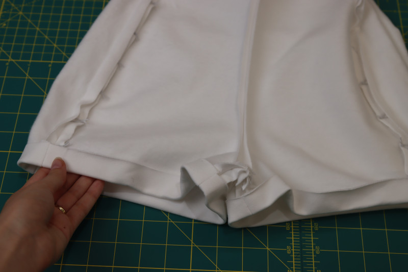 How To Press Shorts Hem Fold - Fleece Backed Stretch Cotton Knit - Mood Fabrics - Fiona Athletic Set Free Sewing Pattern Tutorial - MDF537 - Mood Fabrics Sewciety Blog - Press a ½ inch fold into the hem of the shorts.