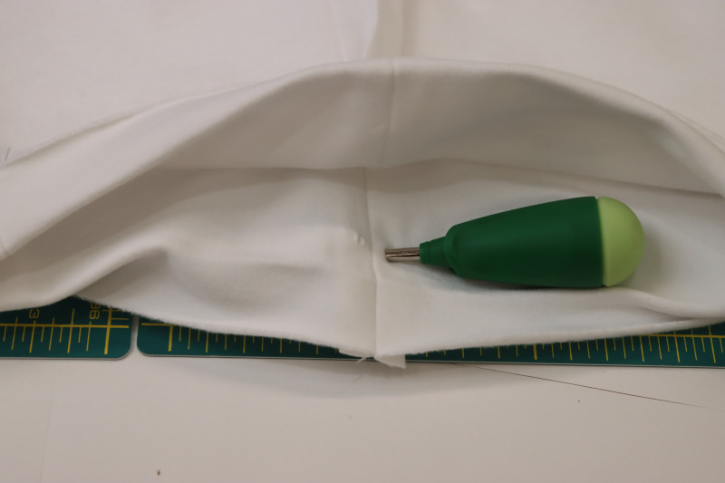 How To Insert Center Front Drawstring Holes - Fleece Backed Stretch Cotton Knit - Mood Fabrics - Fiona Athletic Set Free Sewing Pattern Tutorial - MDF537 - Mood Fabrics Sewciety Blog - Poke two holes at the center front waistline with an awl for the drawstring.