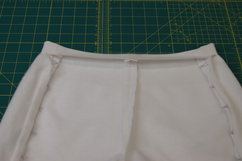 How To Press Shorts Waistline - Fleece Backed Stretch Cotton Knit - Mood Fabrics - Fiona Athletic Set Free Sewing Pattern Tutorial - MDF537 - Mood Fabrics Sewciety Blog - Press a ½ inch fold into the waistline of the shorts.