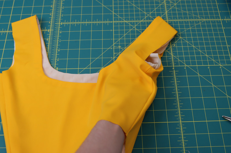 How To Pinch Underarm Lining Main Fabric - Nude Powernet Mesh - Mood Fabrics - Amber Two Piece Cheeky Swimsuit Free Sewing Pattern Tutorial - MDF540 - Mood Fabrics Sewciety Blog - Pinch the lining and main fabric right sides together at the underarm.
