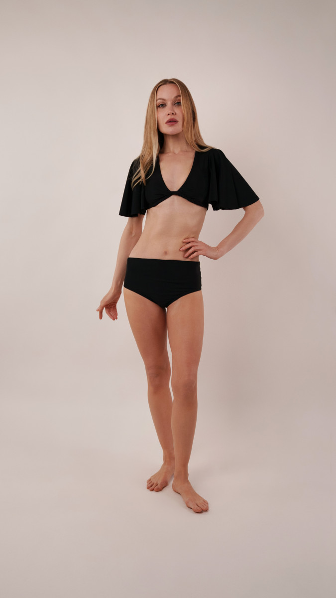 Model wearing Reed Swimsuit Sewing Pattern posing for Swimsuit Sewing Project Ideas. Free Sewing Pattern PDF from Mood Fabrics Sewciety Blog.