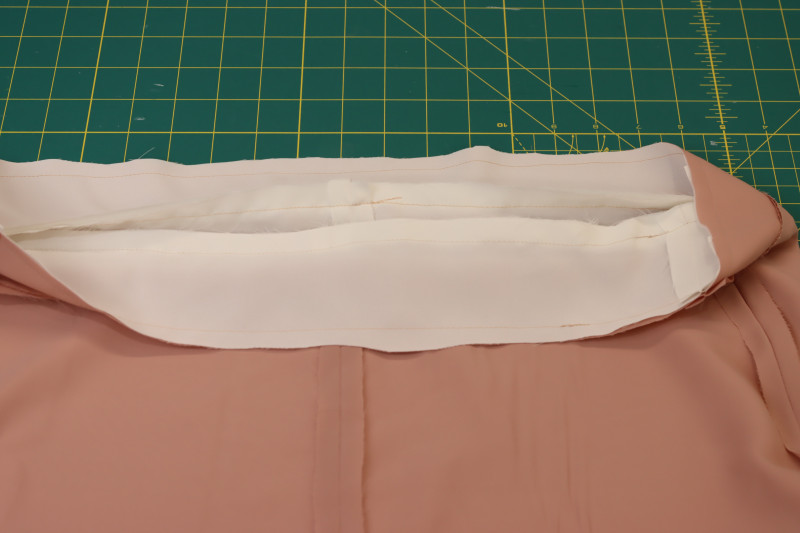 How To Trim Waistband Seam Allowance - White Polyester Double Georgette - Mood Fabrics - Ojai Reversive Wide Leg Pants Free Sewing Pattern Tutorial - MDF545 - Mood Fabrics Sewciety Blog - Trim the waistband seam allowance.