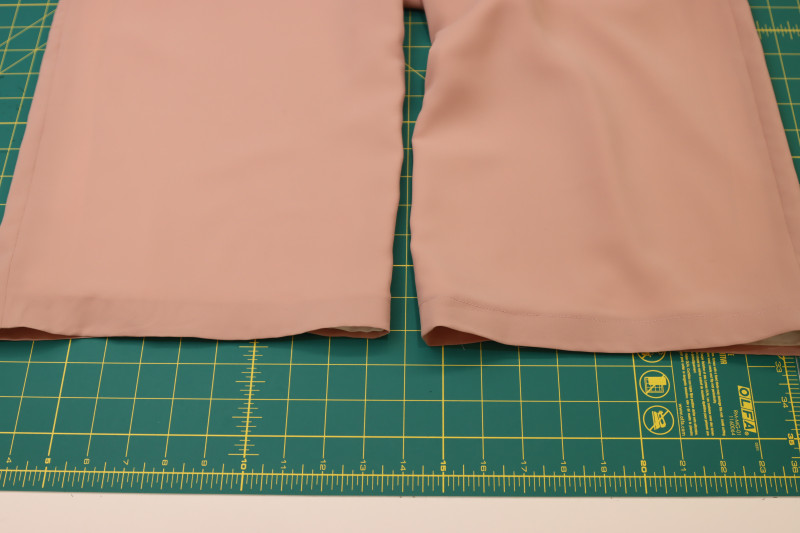 How To Hem Bottoms Of Both Layers - Blush Polyester Double Georgette - Mood Fabrics - Ojai Reversive Wide Leg Pants Free Sewing Pattern Tutorial - MDF545 - Mood Fabrics Sewciety Blog - Press a 1 inch hem into the bottoms of the pants.